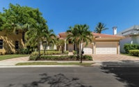 a home with palm trees in the front yard